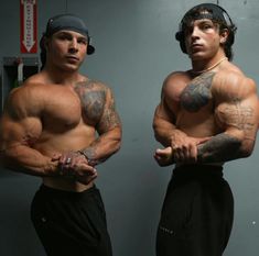 two muscular men standing next to each other