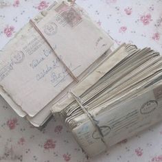 a stack of mail sitting on top of a table