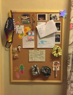 a bulletin board with magnets, pictures and other things on it in a child's room