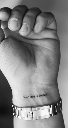 a woman's wrist with the words your time is limited tattooed on her arm