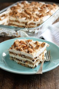 a piece of cake sitting on top of a blue plate next to a glass dish