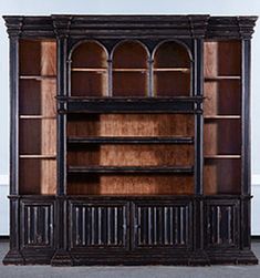 an old wooden bookcase sitting on top of a floor