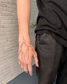 a person with a tattoo on their hand