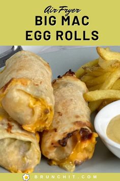 a white plate topped with two burritos and fries next to a bowl of dipping sauce