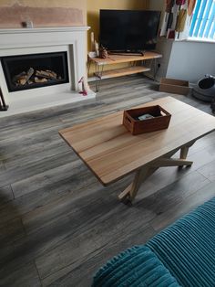 a living room with a couch, coffee table and fireplace