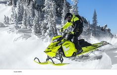 a man riding on the back of a yellow snowmobile