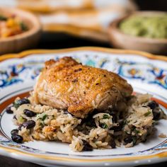 a white plate topped with rice and black beans