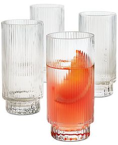 three glasses with different types of drinks in them and one has an orange slice on the rim