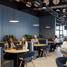 people sitting at tables in an office setting