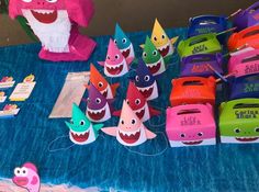 there are many little sharks on the table with their name tags in front of them