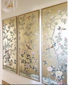 three panels with birds and flowers painted on them are hanging in a hallway next to a wall