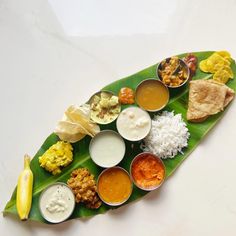 a banana leaf filled with different types of food