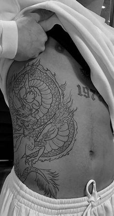 a man with a dragon tattoo on his back