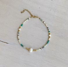 Summer glassbeaded anklet in shades of turquoise, sea foam, soft grey, white, beige with gold stainless steel beads and freshwater pearls Tiny faceted glass beads and freshwater pearls Perfect summer gift Made in Greece  21 cm plus 5 cm extension (8,26 inch plus a 1,96 inch extension chain) Feel free to contact me and send your ankle perimeter if you need a smaller/larger size Beaded Ankle Bracelets, Beaded Ankle, Shades Of Turquoise, Beaded Anklets, Summer Gift, Faceted Glass, Anklet Jewelry, Body Jewellery, Summer Jewelry