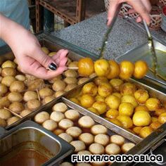 two people reaching for some food in trays