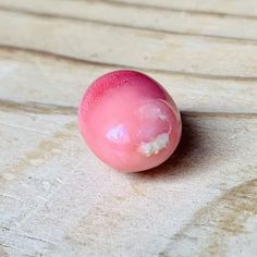 a pink object sitting on top of a wooden table