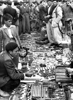 an old black and white photo of men working on various items