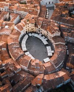 an aerial view of a circular building surrounded by buildings