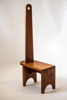 a wooden chair sitting on top of a white floor