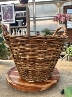 a wicker basket sitting on top of a wooden stand