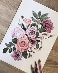 someone is drawing flowers on a piece of paper with colored pencils and watercolor pens