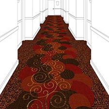 a long hallway with red and brown carpeting