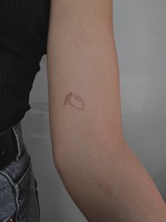 a woman's arm with a small tattoo on the left side of her arm