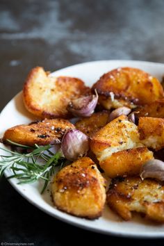 a white plate topped with potatoes and onions