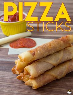 pizza sticks stacked on top of each other with ketchup and mustard in the background