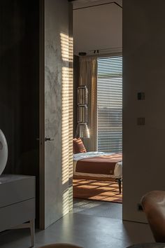 an open door leading to a bedroom with a bed