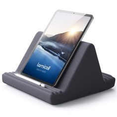 an electronic device is sitting on top of a stand that holds it's phone