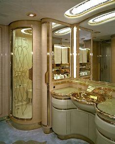 a fancy bathroom with gold fixtures and mirrors