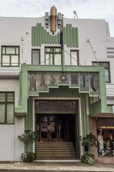 the entrance to an art deco building with green and white trim on it's sides