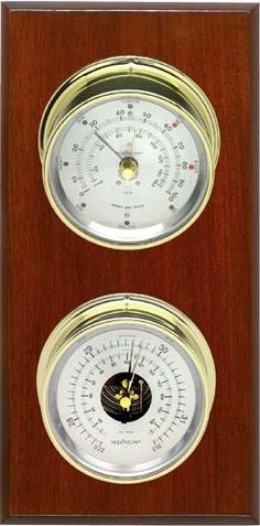 a wooden clock with two different gauges on it