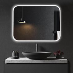 a bathroom with a sink, mirror and lights on the wall above it is shown