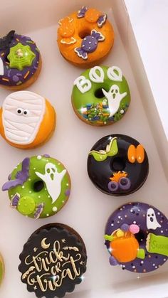 a box filled with lots of decorated doughnuts