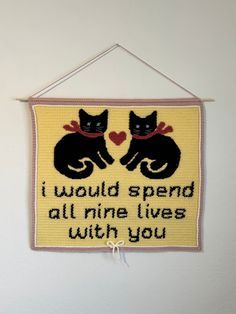 a cross - stitch sign with two black cats on it that says, i would spend all nine lives within you