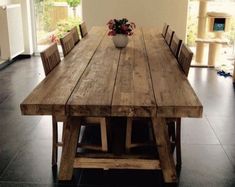 a large wooden table with chairs around it