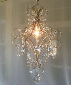 a chandelier hanging from the ceiling in a room