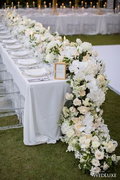 a long table with white flowers on it