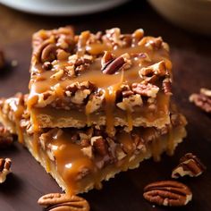 pecan bars stacked on top of each other with caramel drizzle