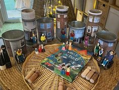 a wicker table topped with lots of figurines