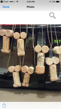 some wine corks are hanging from the side of a black toaster oven door