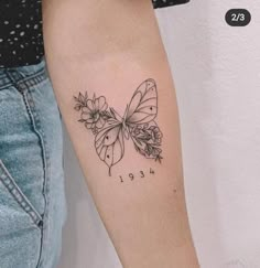 a woman's arm with a butterfly tattoo on the left side of her arm