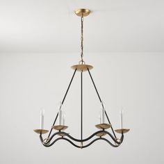 a chandelier hanging from the ceiling in a room with white walls and flooring