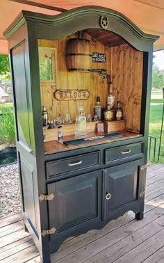 an old fashioned kitchen is built into the side of a wooden structure with drawers and cupboards