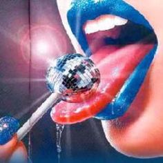 a woman's mouth with blue and red lipstick holding a mirror ball in it