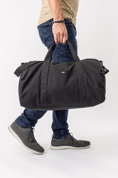 You won’t find a harder-working gym bag than this durable and versatile Aarde Gym Bag for daily outings, outdoor activities, traveling and more! Bag: 11"(H) x 18"(W) x 10"(D) Made with 12 to 14 oz Certified Fairtrade Organic cotton canvas Approximately 32L capacity Main compartment zippers with long pulls Internal zippered hanging pocket sized 8.5” (H) x 8.5” (W) External drop-in pocket 8" (H) x 5" (W) Lead-free YKK metal zippers and fasteners Adjustable strap: up to 44 inches in total Your purc Everyday Satchel Duffle Bag With Pockets, Everyday Black Duffle Bag With Pockets, Sporty Weekender Bag With Functional Pockets For Everyday Use, Functional Weekender Bag With Pockets For Daily Use, Sporty Weekender Bag With Functional Pockets, Functional Gym Bag With Pockets For Everyday Use, Functional Everyday Gym Bag With Pockets, Functional Shoulder Duffle Bag With Pockets, Functional Duffle Shoulder Bag With Pockets