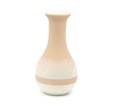 a white and beige vase sitting on top of a table