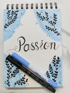 a notebook with the word passion written in cursive writing on it next to a marker